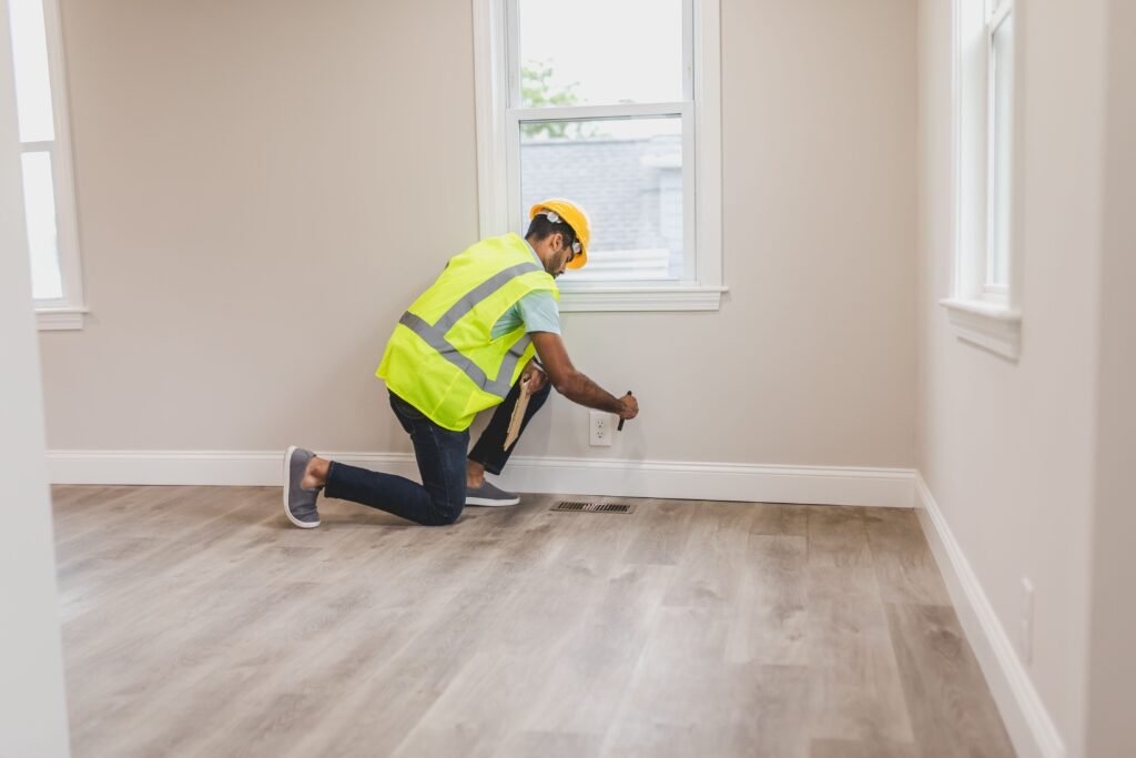A professional in a vest fixing termite damage